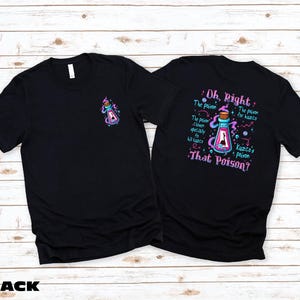 a black t-shirt with a colorful graphic design on the back, featuring a bottle with a purple label and text that reads "That Poison!"