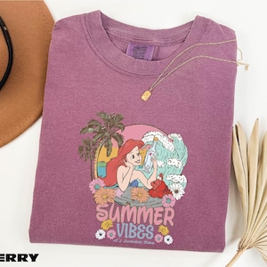 a purple shirt with a picture of a mermaid on it