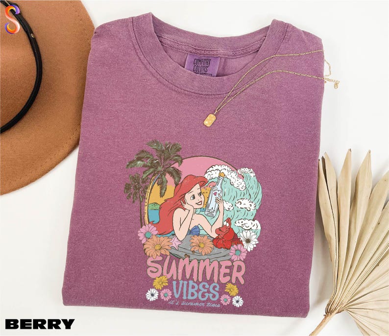 a purple shirt with a picture of a mermaid on it