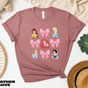 a t - shirt with a picture of princesses on it