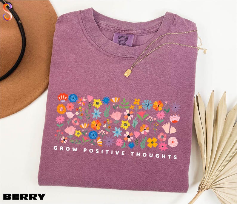 a t - shirt that says grow positive thoughts on it