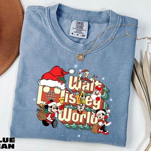 A blue t-shirt with a graphic design featuring Mickey Mouse and other Disney characters, along with the text "Walt Disney World".