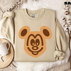 a sweater with a bear face drawn on it