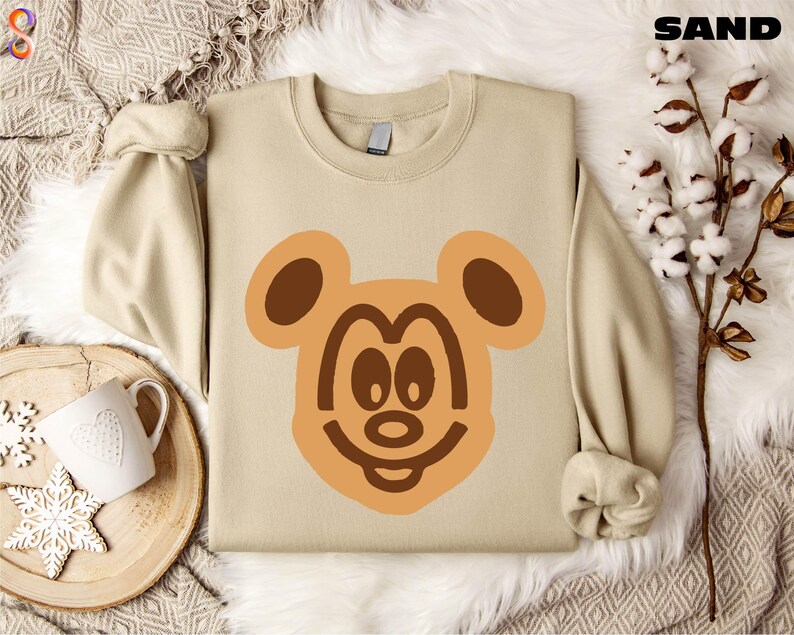 a sweater with a bear face drawn on it
