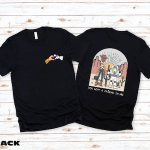 a black t - shirt with a picture of two people on it