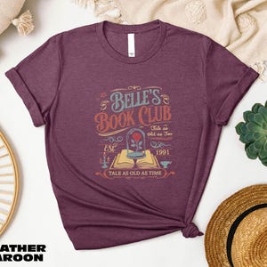 a women's book club t - shirt sitting on top of a table
