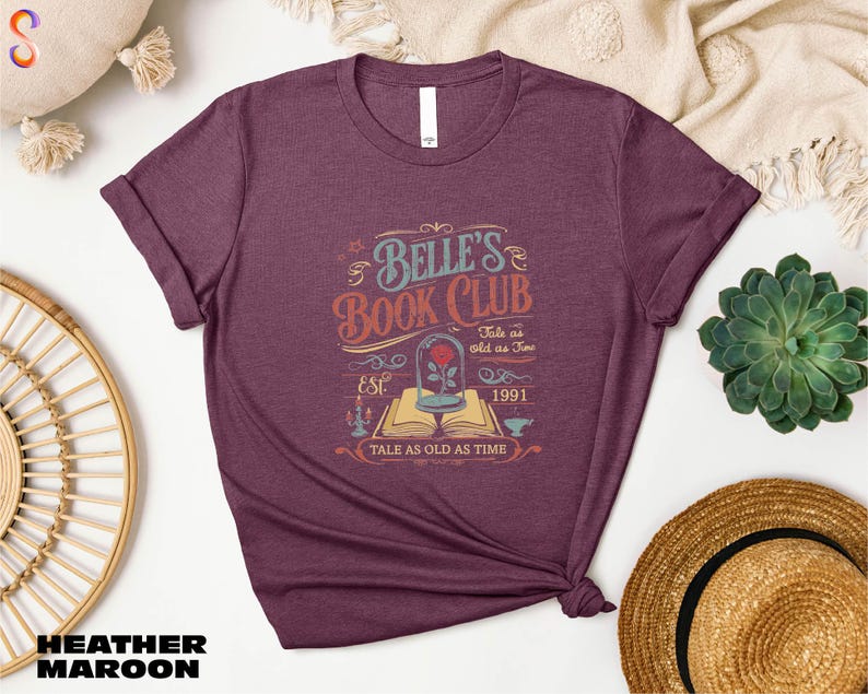 a women's book club t - shirt sitting on top of a table