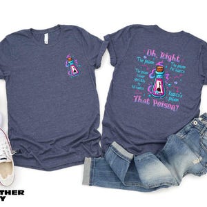 a pair of blue t-shirts with a colorful graphic and text on the back, along with a pair of jeans and sneakers.