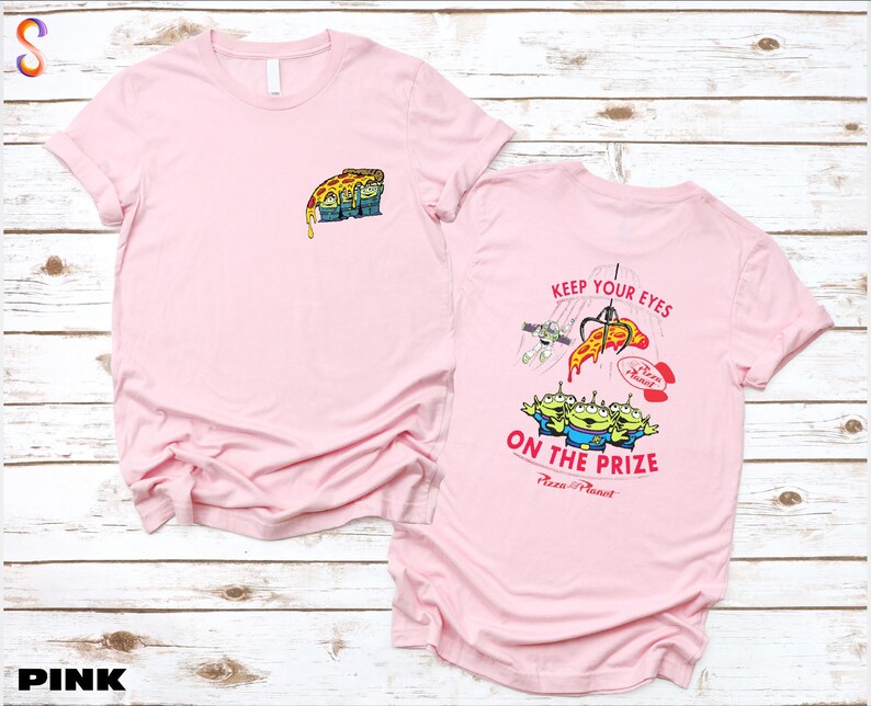 a pink t - shirt with a picture of a cartoon character on it