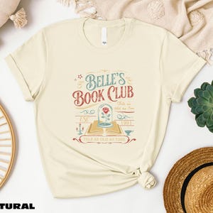 a t - shirt with the words belle's book club on it