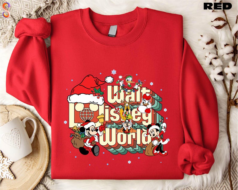 A red sweater with a Disney-themed graphic design, including Mickey Mouse and other Disney characters, along with the text "Disney World".