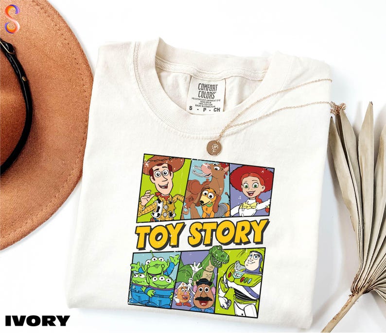 A white t-shirt with a colorful graphic of characters from the Toy Story movie, including Woody, Buzz Lightyear, and other beloved characters.