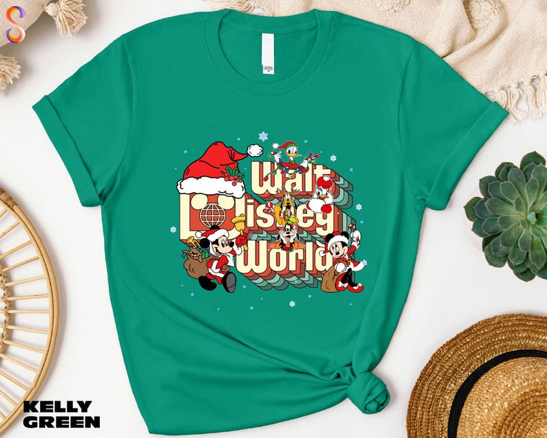 A green t-shirt with a graphic design featuring characters from Disney's "Walt Disney World" and the text "Walt Disney World" printed on it.