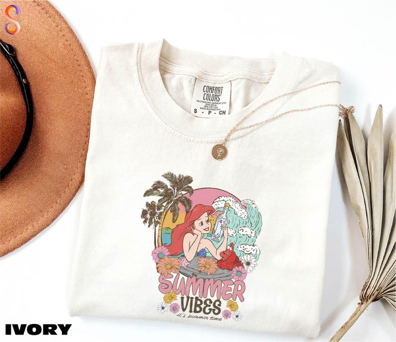 a hat, sunglasses, and t - shirt on a white surface