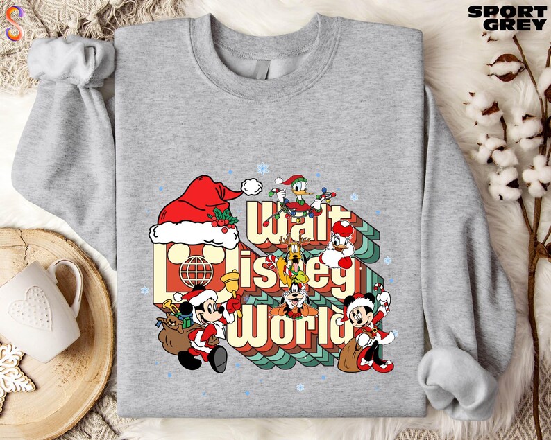 A gray sweatshirt with a graphic design featuring characters from Disney's "Walt Disney World" and the text "Walt Disney World" in a stylized font.