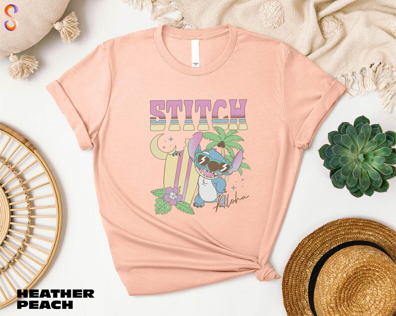 a pink t - shirt with a sloth on it