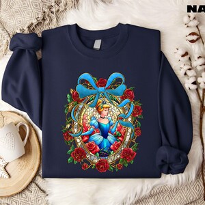 a blue sweatshirt with a picture of a woman with a bow on it