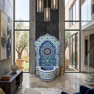May include: A decorative mosaic fountain with a blue, white, and gold color scheme. The fountain has an arched top and a basin. The fountain is in a modern interior with large windows and a marble floor.