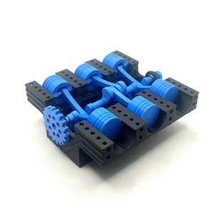 May include: A 3D-printed model of an engine block, featuring blue pistons and a gear, set against a black frame. The model showcases the internal components of an engine, ideal for educational purposes or as a decorative item.