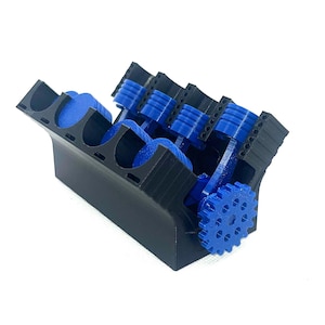 May include: A 3D printed model of a V8 engine with blue pistons and a black engine block. The engine has a gear on the crankshaft.
