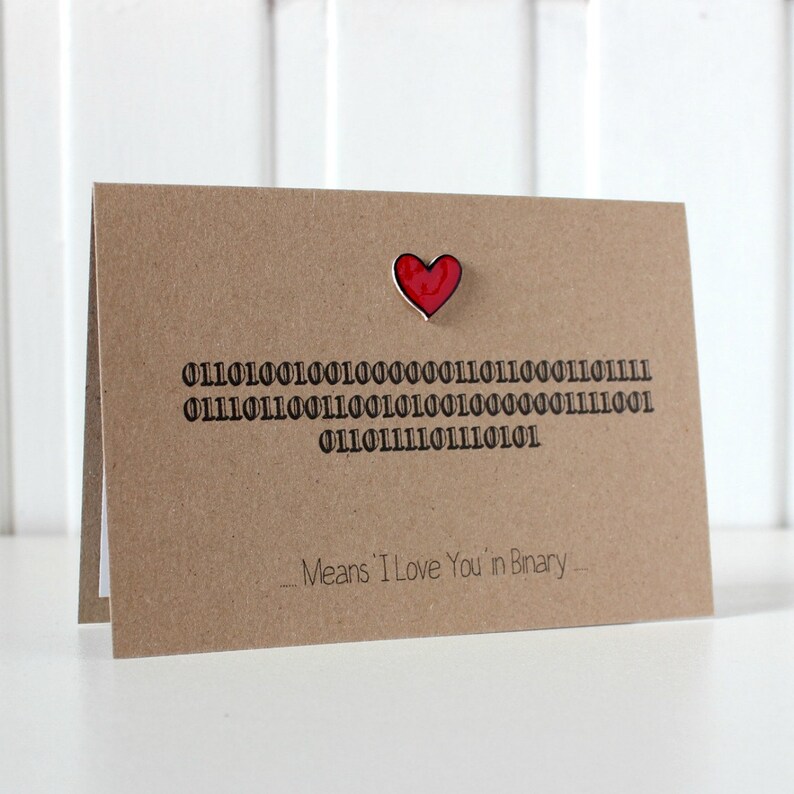 May include: A brown card with a red heart and the text "01101001 01100100 00100000 01110111 01110011 01101001 01101110 01100101 00100000 01111001 01101110 01110011 01110100 01101001 01110010 01110101" and "Means 'I Love You' in Binary".