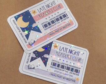 May include: Two rectangular holographic stickers designed as Late Night Readers Club membership cards. They feature a crescent moon, stars, an open book, a barcode, and the text: VIP, LATE NIGHT READERS CLUB, OFFICIAL LIFETIME MEMBERSHIP, MEMBERSHIP NO: 23:59:59, STATUS: NIGHT OWL, I READ PAST MY BEDTIME, and READ NOW, SLEEP LATER.
