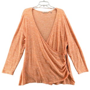 May include: A long-sleeved, orange and white, wrap-style top with a V-neck and a side zipper.
