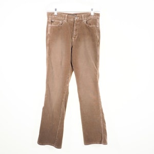 May include: Tan corduroy pants with a classic five-pocket design. The pants are hung on a white hanger against a white background. The corduroy fabric has a soft, textured appearance.