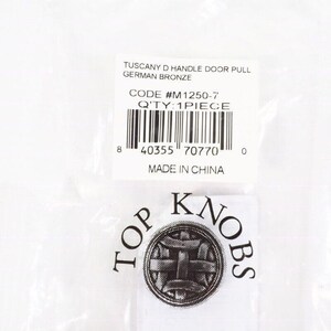 Pode incluir: Uma embalagem contendo uma puxador de porta Tuscany D em bronze alem&atilde;o. O r&oacute;tulo inclui o c&oacute;digo #M1250-7 e a quantidade de 1 pe&ccedil;a. O logotipo Top Knobs tamb&eacute;m &eacute; vis&iacute;vel.