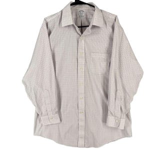 May include: A long-sleeved button-down shirt with a checkered pattern in shades of white and light red. The shirt has a chest pocket and is hanging on a black hanger.