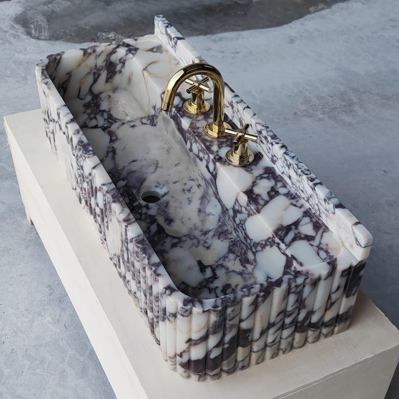 Beautiful marble sink featuring Calacatta Viola’s distinctive veining, available in custom sizes for personalized bathroom solutions.