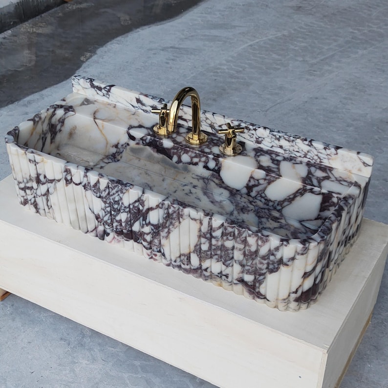 Honed marble sink in Calacatta Viola, showcasing rich veining and natural texture, perfect for bespoke bathroom designs.