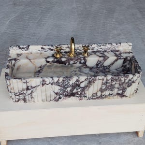 Modern Calacatta Viola marble bathroom sink with unique purple and white patterns, bringing sophistication to your space.