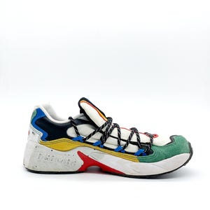 May include: White, black, yellow, blue, and green multi-colored sneakers with black laces. The brand name "DRUMOHR" is printed on the side of the shoe.