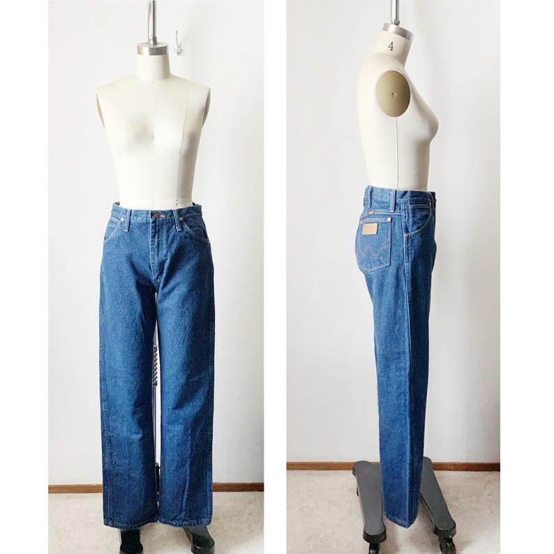 May include: A pair of blue denim jeans with a straight leg fit. The jeans have a high waist and are shown on a mannequin.