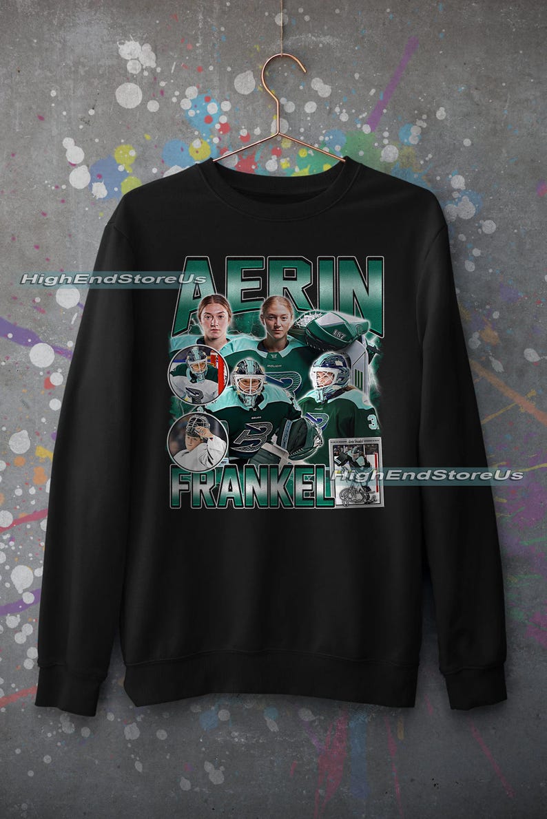 Puede incluir: Sudadera negra con un dise&ntilde;o que presenta el nombre "AERIN FRANKEL" en verde y blanco. El dise&ntilde;o incluye m&uacute;ltiples im&aacute;genes de una jugadora de hockey con uniforme verde y blanco, con el texto "HighEndStoreUs".