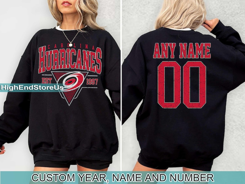 May include: Black sweatshirt with a Carolina Hurricanes logo and the text "Carolina Hurricanes Est 1997". The back of the sweatshirt has the text "Any Name 00".