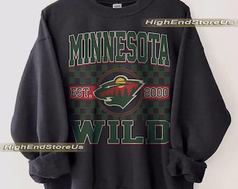 May include: Black sweatshirt featuring the text "MINNESOTA WILD" in green and red lettering. The sweatshirt includes a circular logo with a forest scene and the text "EST. 2000". The words "HighEndStoreUs" are printed on the sweatshirt.
