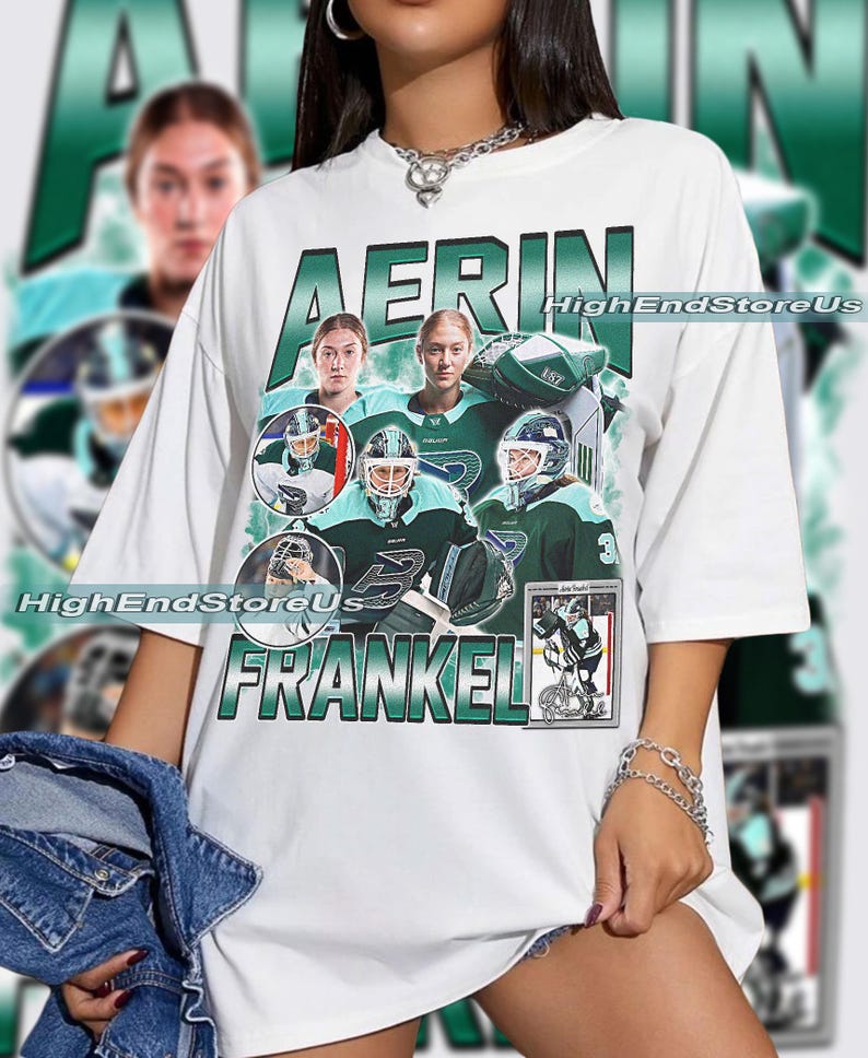 Puede incluir: Camiseta blanca con un dise&ntilde;o gr&aacute;fico verde y blanco. El dise&ntilde;o presenta el nombre "AERIN FRANKEL" e im&aacute;genes de una jugadora de hockey sobre hielo en verde azulado y verde. El texto "HighEndStoreUs" tambi&eacute;n es visible.