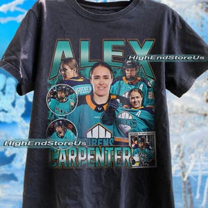 May include: Dark grey t-shirt with the name "ALEX CARPENTER" in teal and orange, and images of a hockey player. The shirt includes the text "HighEndStoreUs".