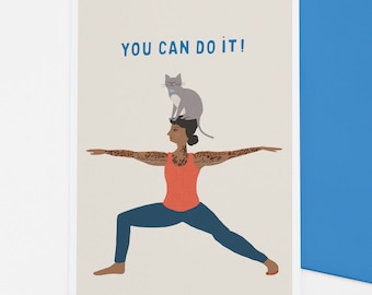 May include: A woman with tattoos is doing a yoga pose with a cat sitting on her head. The text "YOU CAN DO IT!" is written at the top of the card.