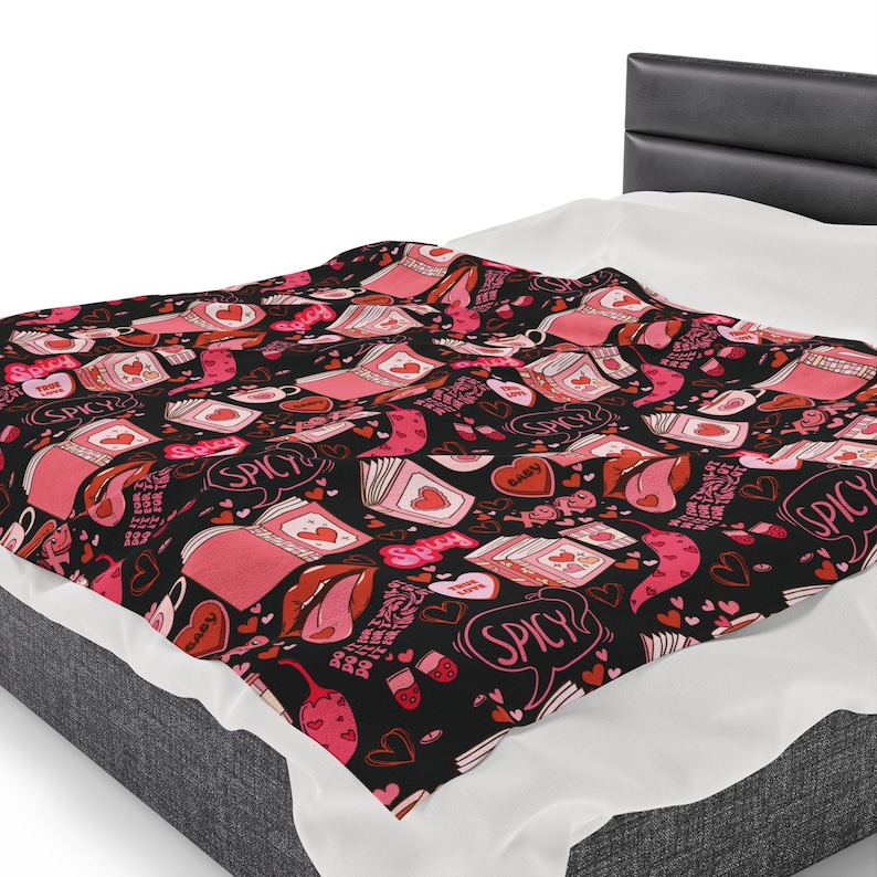 Pink and Black Reading Blanket for Book Nook. Cozy Throw Blanket covered in images of Spicy Romance Books, Coffee, Peppers, and Kisses.