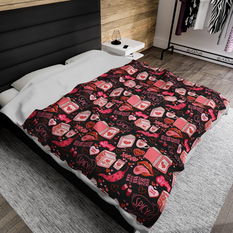 Pink and Black Reading Blanket for Book Nook. Cozy Throw Blanket covered in images of Spicy Romance Books, Coffee, Peppers, and Kisses.