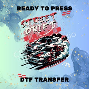 May include: A DTF transfer design featuring two drifting cars with the text "STREET DRIFT" in red and white. The design includes the text "READY TO PRESS" and "DTF TRANSFER" on a blue and gold background.