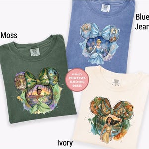 four Disney Princess matching shirts, each with a different design and color. The shirts are arranged in a way that showcases the unique designs and colors of the Disney princess characters.