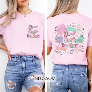 May include: A light pink t-shirt with the text "Your Way's Better" on the front and back. The front text is in a colorful, playful font. The back of the shirt features additional text and graphics in a similar style.