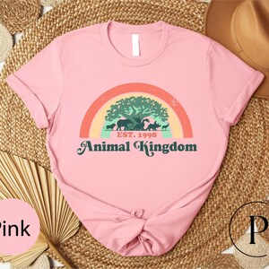 a pink shirt with a picture of an animal kingdom on it