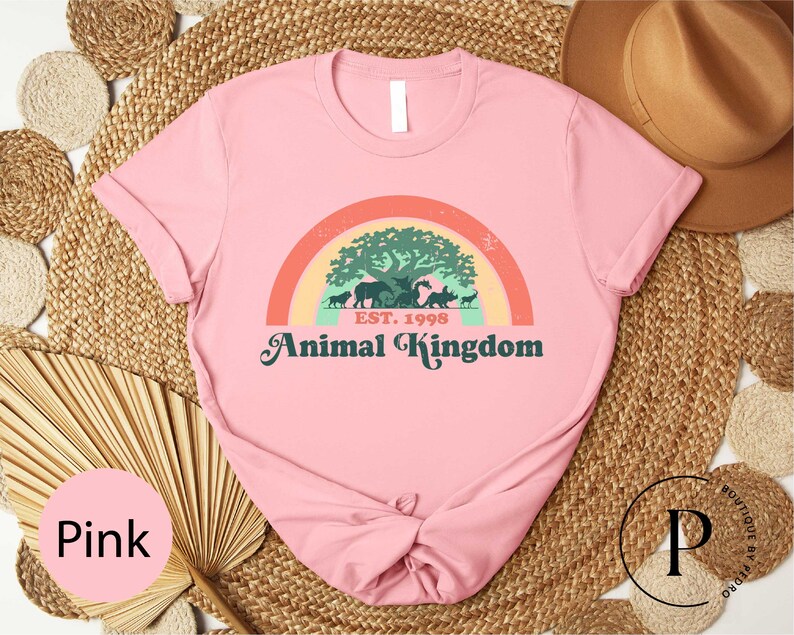 a pink shirt with a picture of an animal kingdom on it