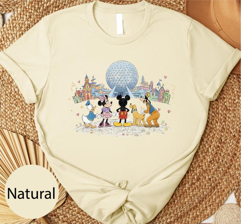 A t-shirt with a cartoon image of Disney characters, including Minnie Mouse, Donald Duck, Goofy, and Mickey Mouse, standing in front of the Earth's observation deck at Walt Disney World.
