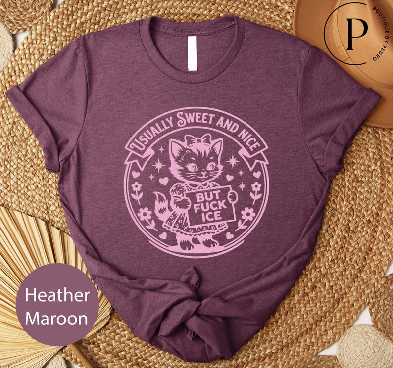 A purple t-shirt with a graphic design featuring a cat and the text "Usually Sweet and Nice BUT FICK ICE" printed on it.